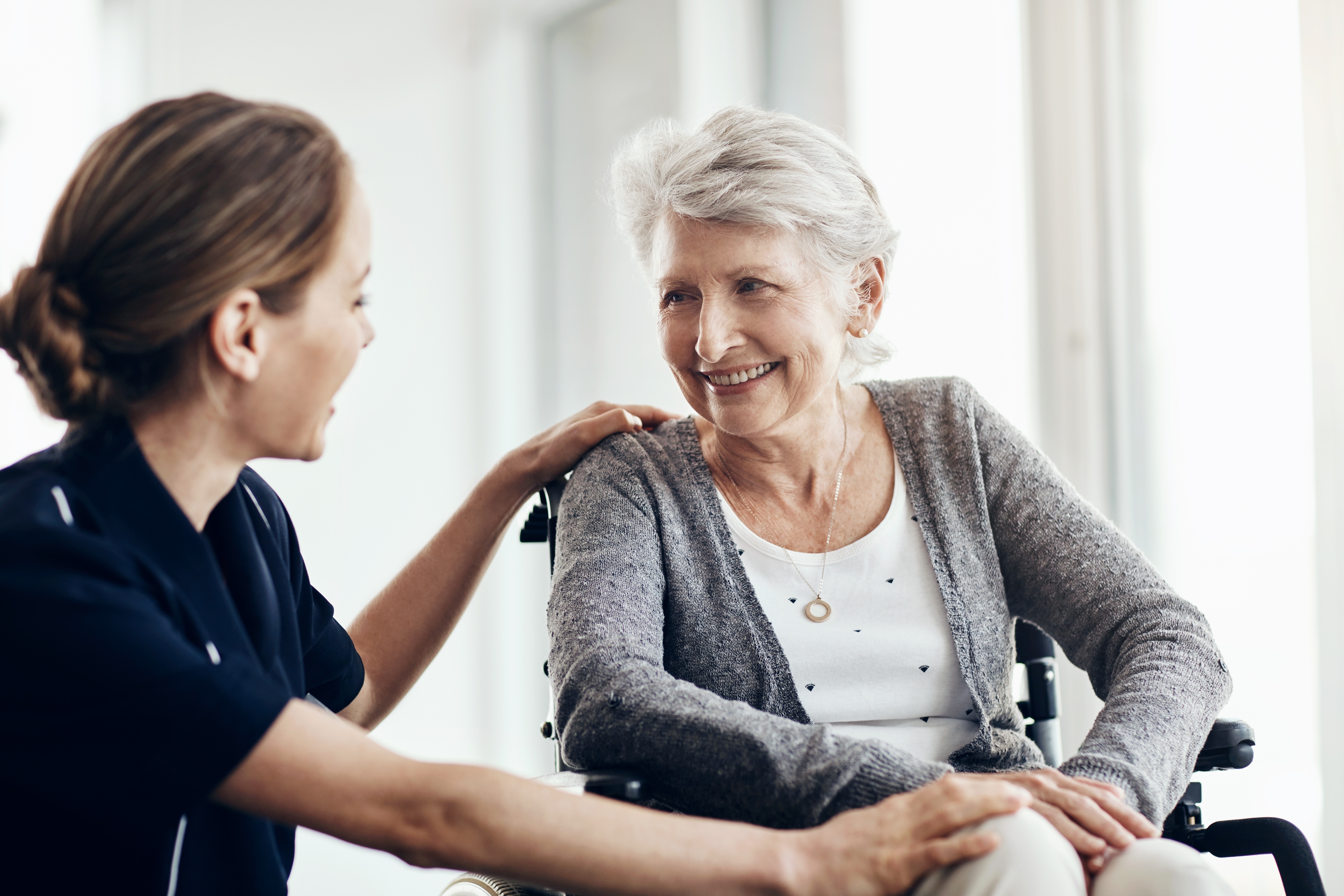 Care assistant helping elderly resident